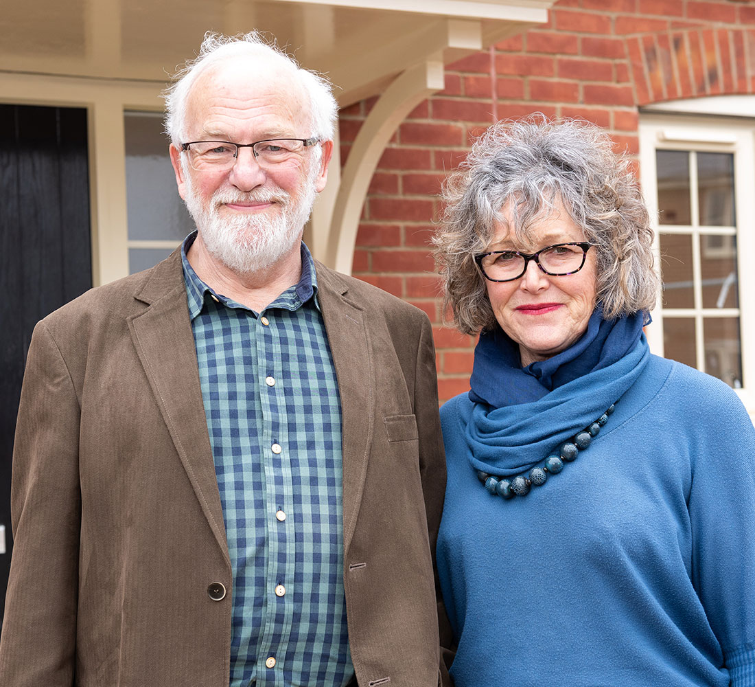 Couple in front of home