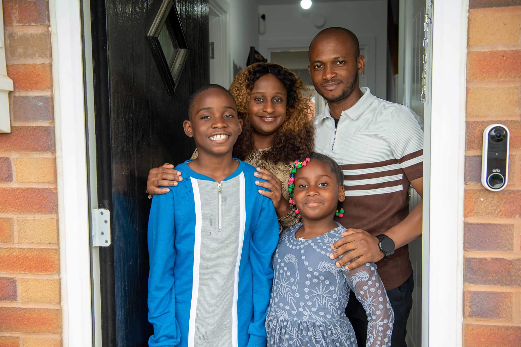 Family in doorway of their home